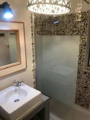 a bathroom with a sink and a shower and a mirror at T3 Townhouse Old Village Vilamoura in Vilamoura