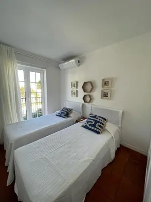 a bedroom with two beds and a window at T3 Townhouse Old Village Vilamoura in Vilamoura