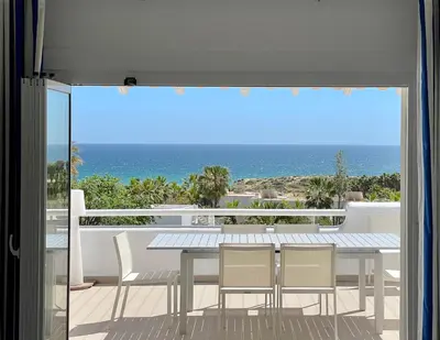 a dining room with a view of the ocean at Vila Marine in Albufeira