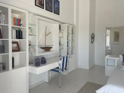 a room with a desk with a sailboat on the wall at Vila Marine in Albufeira