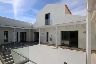 a view of the back of a house with a balcony at L&F House in Algoz