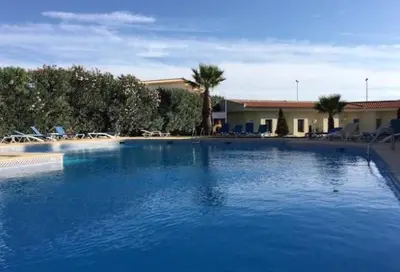 a large pool of blue water in a resort at Belavista Apartment in Albufeira