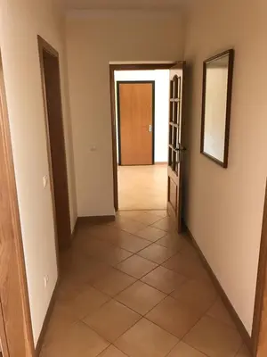 a hallway with two doors and a tiled floor at Palm Garden in Vilamoura