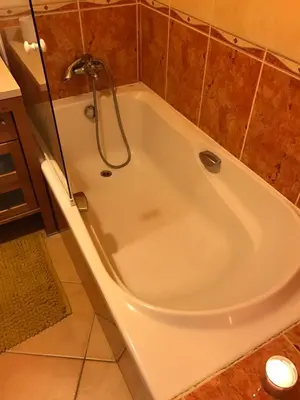 a bath tub with a shower in a bathroom at Palm Garden in Vilamoura
