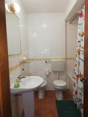 a bathroom with a white sink and a toilet at Apartamentos Arcada in Quarteira