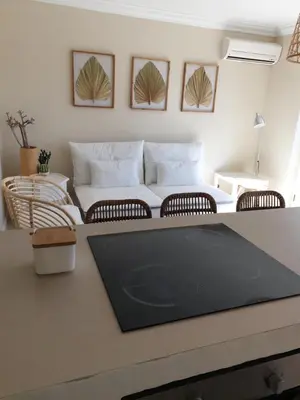 a living room with a couch and a table at T2 Apartment Old Village Vilamoura in Vilamoura