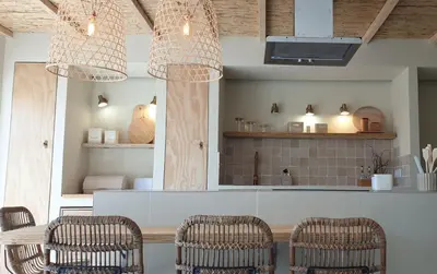 a kitchen with three wicker chairs and a counter at T2 Apartment Old Village Vilamoura in Vilamoura