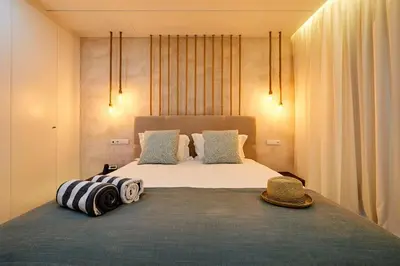 a bedroom with a large bed with a hat on it at Areias Senses in Albufeira