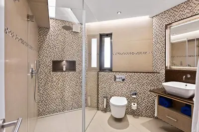 a bathroom with a shower and a toilet and a sink at Four Seasons Country Club in Quinta do Lago