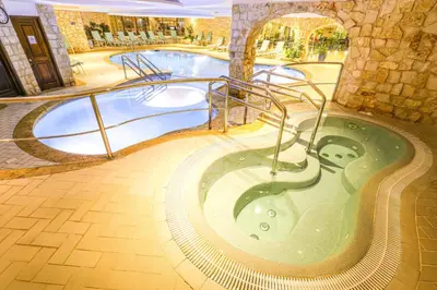 a swimming pool with a jacuzzi tub in a building at Four Seasons Country Club in Quinta do Lago