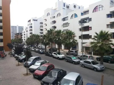 a bunch of cars parked in a parking lot at Regueiró Quarteira Beach Apartment in Quarteira