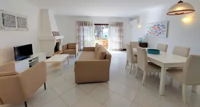 a living room with a table and a dining room at Vilamouratenis 'Blue' by SAPvillas in Vilamoura