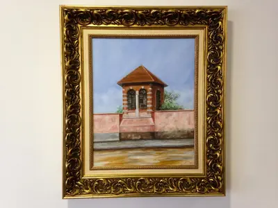 a painting of a church in a frame on a wall at Vila Algarvia Boutique & Suites in Albufeira
