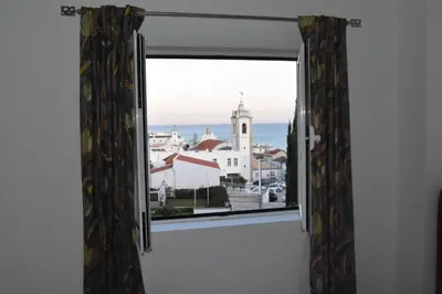 a window with a view of a city at Vila Algarvia Boutique & Suites in Albufeira