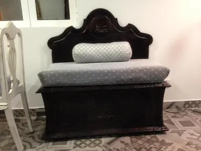 a black bed with polka dot sheets on it at Vila Algarvia Boutique & Suites in Albufeira