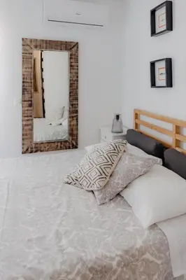 a bedroom with a bed and a mirror at Home Santa Clara in Albufeira