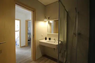 a bathroom with a sink and a glass shower at Carmo Twenties Apartment in Faro