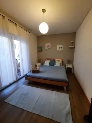 a bedroom with a bed and a large window at Carmo Twenties Apartment in Faro