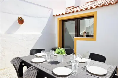 a table and chairs on a patio at Vila - Mar - Private outdoor Jacuzzi - wifi & airco - by bedzy in Albufeira