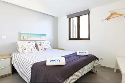a bedroom with a bed with two pillows on it at Vila - Mar - Private outdoor Jacuzzi - wifi & airco - by bedzy in Albufeira