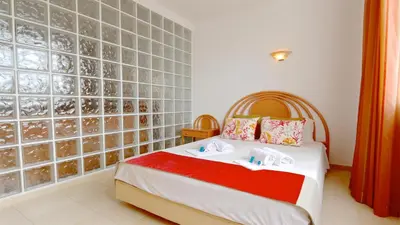 a bedroom with a bed and a tile wall at Terraços do Mar 46- Clever Details in Vilamoura