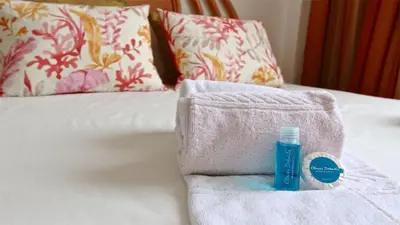a towel and a bottle of mouth wash on a bed at Terraços do Mar 46- Clever Details in Vilamoura