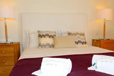 a bedroom with a bed with two pillows on it at Golf Mar Village - Clever Details in Vilamoura