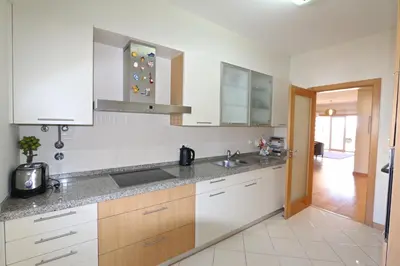 a kitchen with white cabinets and a sink at Golf Mar Village - Clever Details in Vilamoura