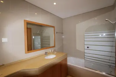 a bathroom with a sink and a mirror and a tub at Golf Mar Village - Clever Details in Vilamoura