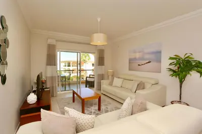 a living room with a couch and a table at Praia Village 104 - Clever Details in Vilamoura