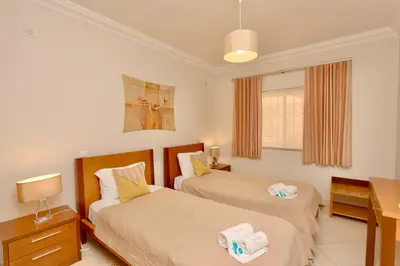 a bedroom with two beds and a desk at Praia Village 104 - Clever Details in Vilamoura