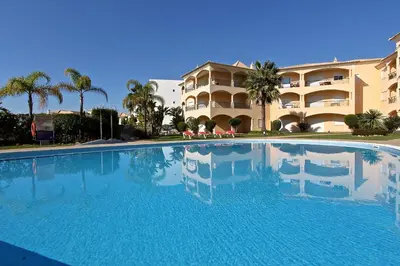 a large swimming pool in front of a building at Praia Village 104 - Clever Details in Vilamoura
