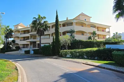 a large apartment building with a road in front of it at Praia Village 104 - Clever Details in Vilamoura