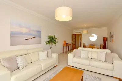 a living room with two white couches and a table at Praia Village 104 - Clever Details in Vilamoura