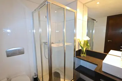 a bathroom with a shower with a toilet and a sink at Monte Laguna - Clever Details in Vilamoura