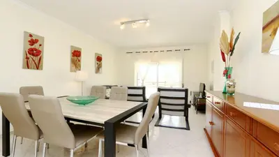 a dining room with a table and chairs at Falésia Marina - Clever Details in Vilamoura
