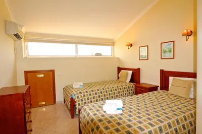 a hotel room with two beds and a window at Falésia Marina - Clever Details in Vilamoura