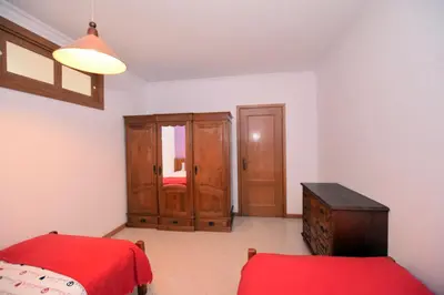 a living room with a chair and a television at Old town in Albufeira