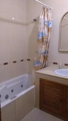 a kitchen with wooden cabinets and a sink at Old town in Albufeira