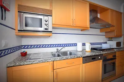 a kitchen with a sink and a microwave at Old town in Albufeira