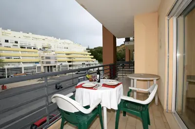 a table and chairs on a balcony with a view at Old town in Albufeira