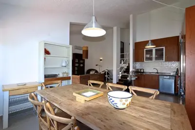 a kitchen and dining room with a wooden table at Marina Parque - Clever Details in Vilamoura