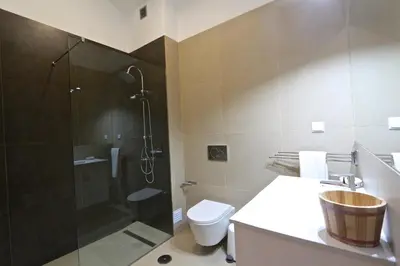 a bathroom with a shower and a toilet and a sink at Marina Parque - Clever Details in Vilamoura