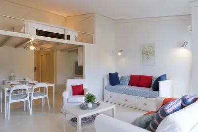 a living room with a couch and a loft bed at BmyGuest - Quinta do Lago Mezzanine Apartment in Almancil