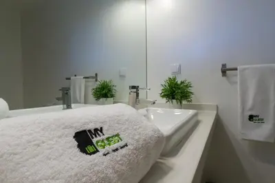 a white bathroom with a sink and a towel at BmyGuest - Quinta do Lago Mezzanine Apartment in Almancil