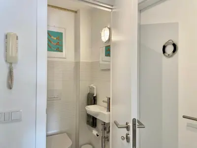 a white bathroom with a shower and a sink at Ocean Balcony apartment terrace sea view and pool in Albufeira