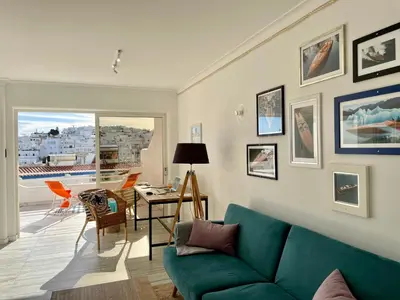 a living room with a green couch and a table at Ocean Balcony apartment terrace sea view and pool in Albufeira