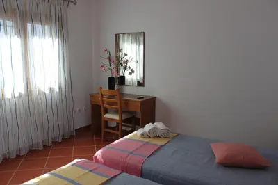 a bedroom with a desk and a bed and a chair at Apartamentos Colina do Mar Downtown Albufeira in Albufeira