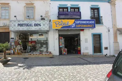 a store with signs on the side of a building at Apartamentos Colina do Mar Downtown Albufeira in Albufeira