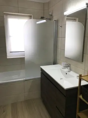 a bathroom with a sink and a mirror and a tub at Old Village in Vilamoura